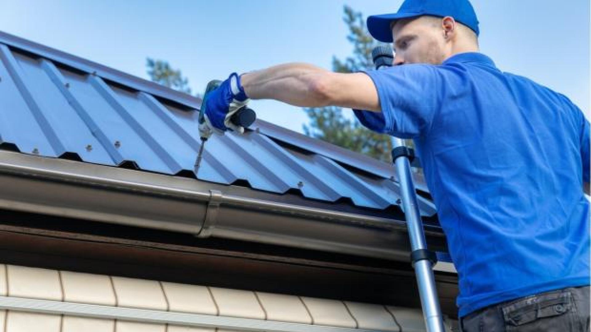 View of person drilling into a roof