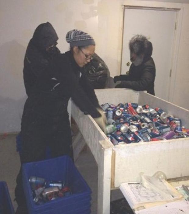  Counting aluminum cans before issuing a refund to a community resident.