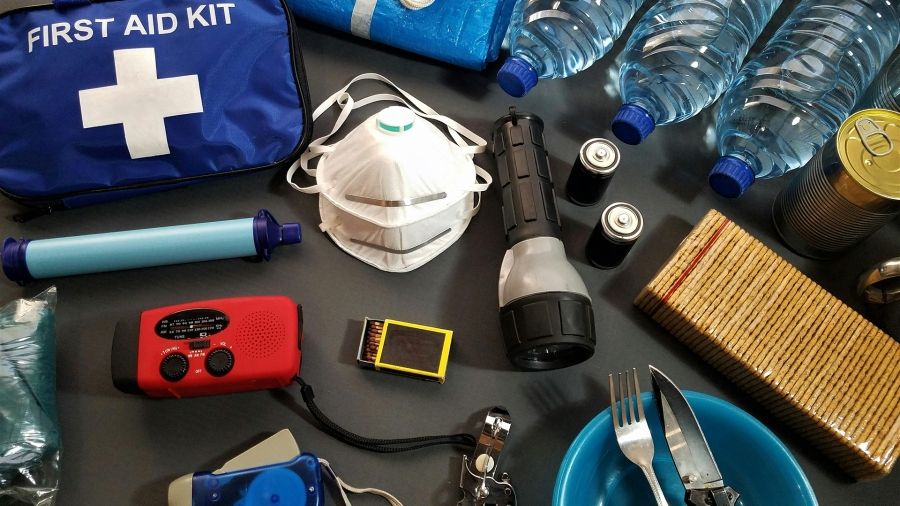 Emergency preparedness kit with first aid supplies, radio, flashlight, and emergency blankets